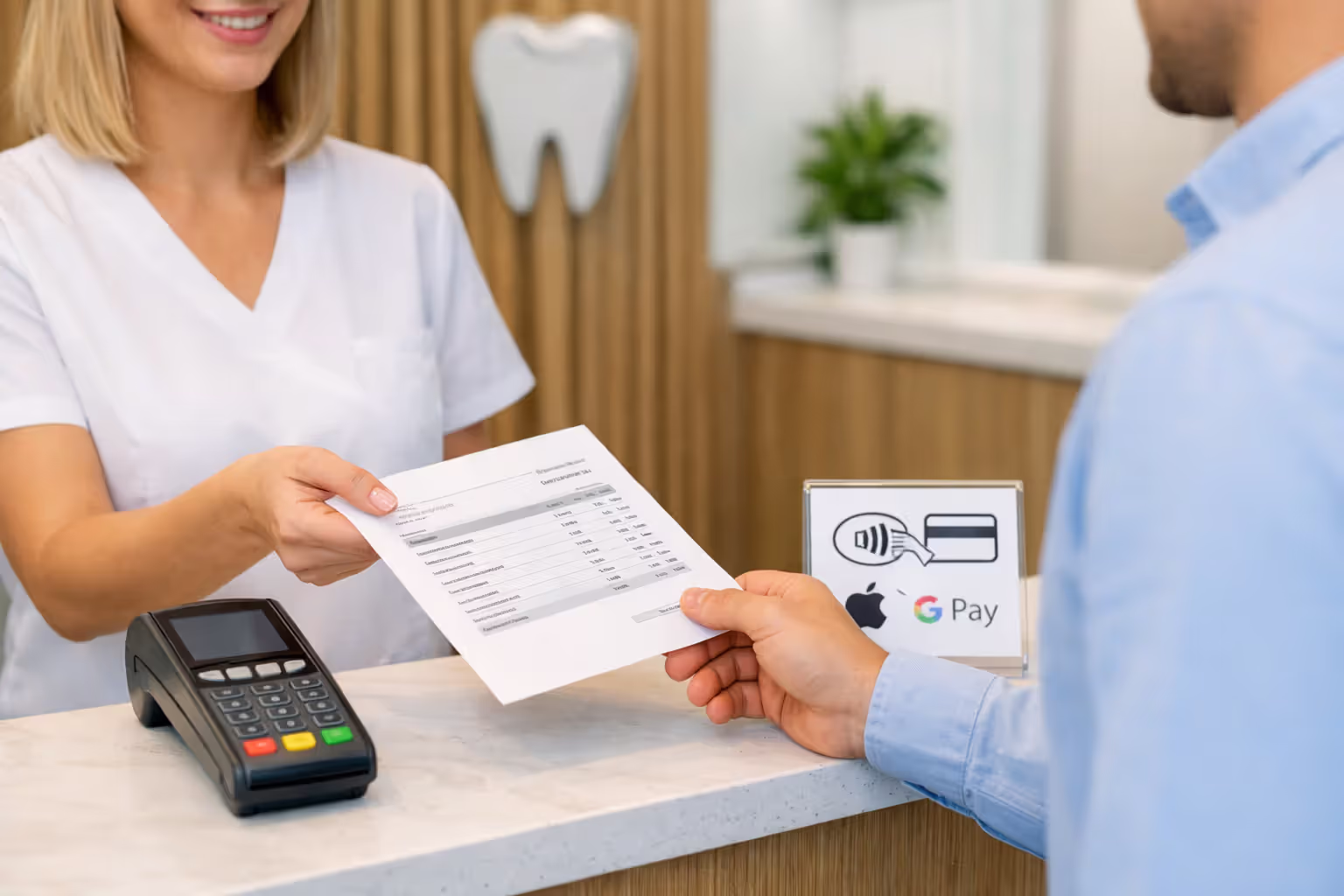 Dental office front desk with a receptionist handing a treatment cost estimate document to a patient, payment terminal and payment method icons visible on the counter in a modern bright clinic interior